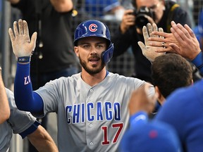 Chicago Cubs right fielder Kris Bryant (17) is greeted after hitting a home run against the Los Angeles Dodgers at Dodger Stadium.