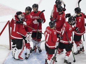 Canada celebrates after defeating Russia 5-0 in IHF World Junior Hockey Championship semifinal action on Monday, Jan. 4, 2021 in Edmonton.
