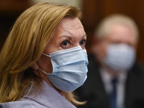 Ontario Health Minister Christine Elliott listens as Ontario Premier Doug Ford gives an update regarding the Ontario COVID-19 vaccine during the COVID-19 pandemic in Toronto on January 5, 2021.