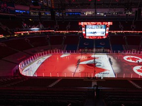 The Montreal Canadiens and the Vancouver Canucks line up at centre ice for the Canadian national anthem prior to the Vancouver Canucks home opener of the 2021 NHL hockey season at Rogers Arena on January 20, 2021 in Vancouver, Canada. (Rich Lam/Getty Images)