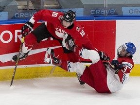 Canada's Dylan Holloway (10) upends Czech Republic's David Jiricek (8) in their IIHF world junior championship quarter-final Saturday, Jan. 2, 2021 in Edmonton.