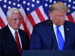 In this file photo, U.S. President Donald Trump and U.S. Vice President Mike Pence speak during election night in the East Room of the White House in Washington, D.C., early on Nov. 4, 2020.