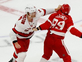 Red Wings centre Sam Gagner (right) and Hurricanes defenceman Dougie Hamilton (left) fight during NHL action at Little Caesars Arena in Detroit, Jan. 14, 2021.