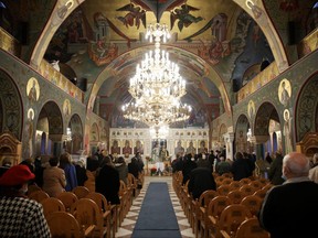 Faithfuls attend a service for Orthodox Epiphany celebrations, after Holy Synod rejected government decision to close churches on Epiphany day, amid the coronavirus disease pandemic, in Athens, Greece, January 6, 2021.