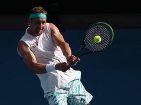 Tennys Sandgren of the United States plays a backhand during his Men’s Singles Quarterfinal match against Roger Federer of Switzerland on day nine of the 2020 Australian Open at Melbourne Park on January 28, 2020 in Melbourne, Australia.