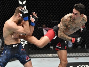 In this handout image provided by UFC, Max Holloway (right) kicks Calvin Kattar during the UFC Fight Night event at Etihad Arena January 17, 2021 in Abu Dhabi.