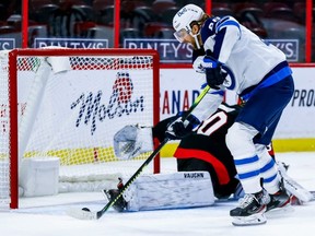 Winnipeg Jets right winger Blake Wheeler scores on Ottawa Senators goaltender Matt Murray last night. Errol McGihon/Postmedia