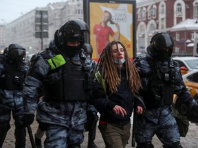 Law enforcement officers detain a person during a rally in support of jailed Russian opposition leader Alexei Navalny in Moscow, Sunday, Jan. 31, 2021.