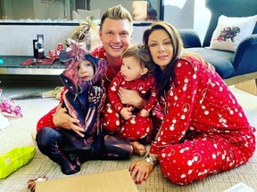 Nick and Lauren Carter pose for a Christmas Day snap with their two children.