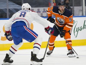 Edmonton Oilers Connor McDavid (97) skates past Montreal Canadiens Ben Chiarot (8) on Saturday, Jan. 16, 2021, in Edmonton.