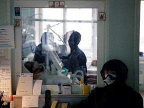 A medical specialist wearing protective gear is pictured at the intensive care unit of the Vologda City Hospital Number 1, where patients suffering from COVID-19 are treated, in Vologda, Russia, Nov. 24, 2020.