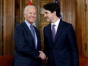 Prime Minister Justin Trudeau (right) shakes hands with Joe Biden during a meeting on Parliament Hill in Ottawa, December 9, 2016.