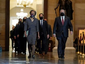 Clerk of the House Cheryl Johnson along with House Sergeant-at-Arms Tim Blodgett lead the Democratic House impeachment managers as they walk through the Statuary Hall on Capitol Hill to deliver to the Senate the article of impeachment alleging incitement of insurrection against former President Donald Trump, in Washington, D.C., Monday, Jan. 25, 2021.