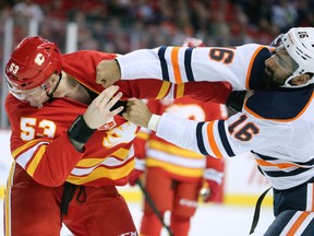 The Calgary Flames' Buddy Robinson trades punches with the Edmonton Oilers' Jujhar Khaira in Calgary on Saturday, Feb. 1, 2020.