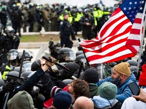 Supporters of U.S. President Donald Trump fight with riot police outside the Capitol building on Jan. 6, 2021, in Washington, DC.