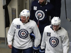 Paul Stastny (left) heads for the ice with Nikolaj Ehlers (right) and Nate Thompson during Winnipeg Jets training camp at Bell MTS Iceplex in Winnipeg on Mon., Jan. 4, 2021. Kevin King/Winnipeg Sun/Postmedia Network