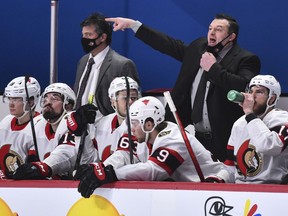 Head coach of the Ottawa Senators D. J. Smith pulls down his mask to call out instructions against the Montreal Canadiens during the third period at the Bell Centre on February 4, 2021 in Montreal, Canada. The Ottawa Senators defeated the Montreal Canadiens 3-2.