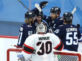 Ottawa Senators goaltender Matt Murray watches as the Winnipeg Jets celebrate a goal from Blake Wheeler during Thursday's game.