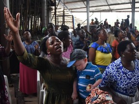 Believers attend Sunday mass without wearing masks and social distancing at Ufunuo na Uzima Church in Dar es Salaam on Feb. 7, 2021. For more than six months, Tanzania has tried to convince the world it has been cured of the coronavirus through prayer.