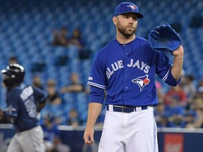 Blue Jays relief pitcher David Phelps (35) waits for a new ball as Tampa Bay Rays center fielder Guillermo Heredia (54) rounds the bases after hitting a two run home run in the eighth inning at Rogers Centre July 28, 2019.