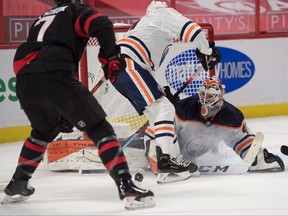 Edmonton Oilers goalie Mike Smith (41) makes a save in front of Ottawa Senators left wing Brady Tkatchuk (7) in the second period at the Canadian Tire Centre on Monday night.