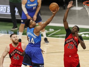 Bucks' Giannis Antetokounmpo goes to the rim while Raptors' Chris Boucher defends during the second quarter at Fiserv Forum on Thursday, Feb. 18, 2021. JEFF HANISCH/USA TODAY SPORTS