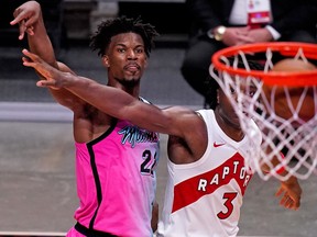 Heat forward Jimmy Butler (22) watches the ball into the net after shooting over Toronto Raptors forward OG Anunoby during the Heat's win on Wednesday.