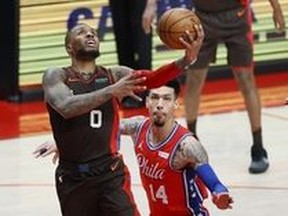 Portland Trail Blazers point guard Damian Lillard goes to the hoop against Philadelphia 76ers small forward Danny Green last week. Lillard deserves a spot in the all-star game, writes Ryan Wolstat.