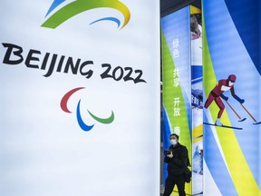 A journalist looks at a display at the exhibition centre for the Beijing 2022 Winter Olympics in Yaqing district, Beijing, China, Feb. 5, 2021.