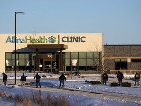 Law enforcement officers from the ATF canvas the area outside an Allina Health Clinic where a shooting took place in Buffalo, Minn., Tuesday, Feb. 9, 2021.