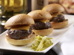 A plate of mouth-watering cheeseburgers.