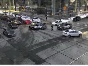 Toronto Police closed off the intersection at York St. and Lake Shore Blvd. after reports of bottles being thrown from a condo balcony on Sunday, Feb. 22, 2021