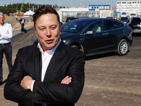 In this file photo, Tesla CEO Elon Musk talks to media as he arrives to visit the construction site of the future U.S. electric car giant Tesla in Gruenheide near Berlin on Sept. 3, 2020.