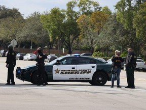 Law enforcement officers block off an area near where several FBI agents were shot as they served a warrant in a child exploitation case in Sunrise, Fla., Tuesday, on Feb. 2, 2021.