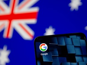 A smartphone with a Google app icon is seen in front of the displayed Australian flag in this illustration, January 22, 2021.