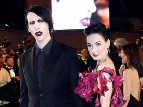 Singer Marilyn Manson and his wife burlesque performer Dita Von Teese pose upon arriving at the Festival Palace for the premiere of U.S. director Richard Kelly's film "Southland Tales" at the Cannes Film Festival in Cannes, southern France, May 21, 2006.