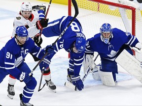 Maple Leafs goaltender Frederik Andersen looks for the puck as Ottawa Senators' Connor Brown and Leafs defenceman T.J. Brodie battle and Leafs' John Tavares looks on during the first period in Toronto on Wednesday, Feb. 17, 2021.