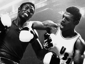 In this file photo taken in August 1976, U.S. boxer Leon Spinks, right, punches opponent Cuba's Sixto Soria during the 81kg finals of the Summer Olympic Games in Montreal.