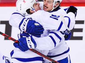 Mitch Marner (left) celebrates with Maple Leafs teammate and linemate Auston Matthews in a game against Calgary on Jan. 26. Marner’s 21 points lead Toronto in scoring, while Matthews has scored in eight games in a row, with his 11 goals atop the NHL through Monday’s games.