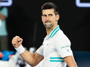 Serbia's Novak Djokovic celebrates winning against Russia's Aslan Karatsev during their semifinal match at the Australian Open in Melbourne, Thursday, Feb. 18, 2021.