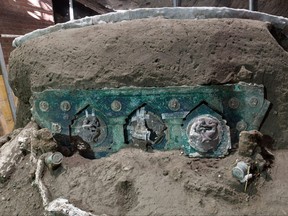 A photo handout on Feb. 27, 2021 by the archeological park of Pompeii shows a detail of a large Roman four-wheeled ceremonial chariot after it was discovered near Pompeii.