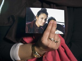 In this file photo taken on February 22, 2015 Renu, eldest sister of missing British girl Shamima Begum, holds a picture of her sister while being interviewed by the media in central London.