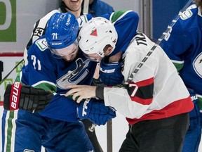 Vancouver Canucks forward Zack MacEwen fights with Ottawa Senators forward Brady Tkachuk on Jan. 28, 2021.