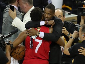 Toronto Raptors president Masai Ujiri (right) hugs guard Kyle Lowry (7).