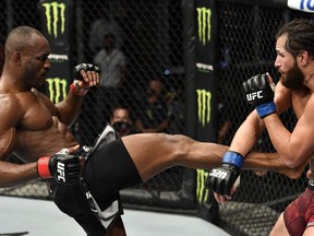 A handout image released by the UFC on July 12, 2020, shows Kamaru Usman kicking Jorge Masvidal in their welterweight championship fight during the UFC 251 event at UFC Fight Island in Abu Dhabi's Yas Island.