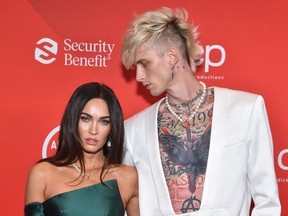 In this handout image courtesy of ABC rapper Machine Gun Kelly and actress Megan Fox arrive for the 2020 American Music Awards at the Microsoft theatre on November 22, 2020 in Los Angeles.