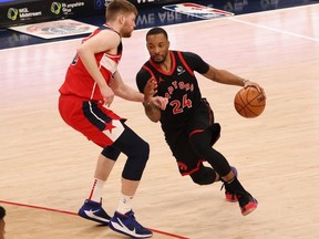 Toronto Raptors guard Norman Powell drives to the basket as Washington Wizards forward Davis Bertans defends in the third quarter at Capital One Arena.