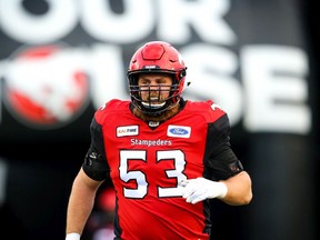 Brad Erdos of the Calgary Stampeders runs onto the field during player introductions before facing the BC Lions in CFL football on Saturday, October 13, 2018. Al Charest/Postmedia