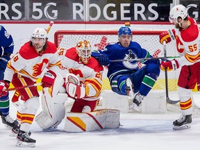 Vancouver Canucks forward Tanner Pearson (No. 70) battles with Calgary Flames defenceman Christopher Tanev (8) and defenseman Noah Hanifin (No. 55) in front of goalie Jacob Markstrom in the second period at Rogers Arena. Bob Frid/USA TODAY Sports