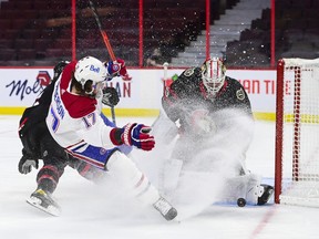 Ottawa Senators goaltender Matt Murray (30) stops a shot from Montreal Canadiens right wing Josh Anderson (17) as Senators defenceman Mike Reilly (5) defends during first-period NHL action in Ottawa on Tuesday, Feb. 23, 2021.